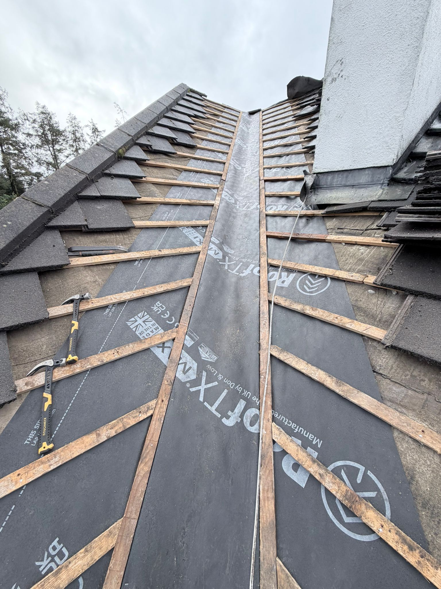 Satisfied homeowners with professional roof installation Ireland